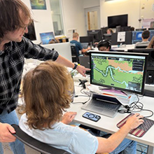 two men looking at a graphic on a computer screen